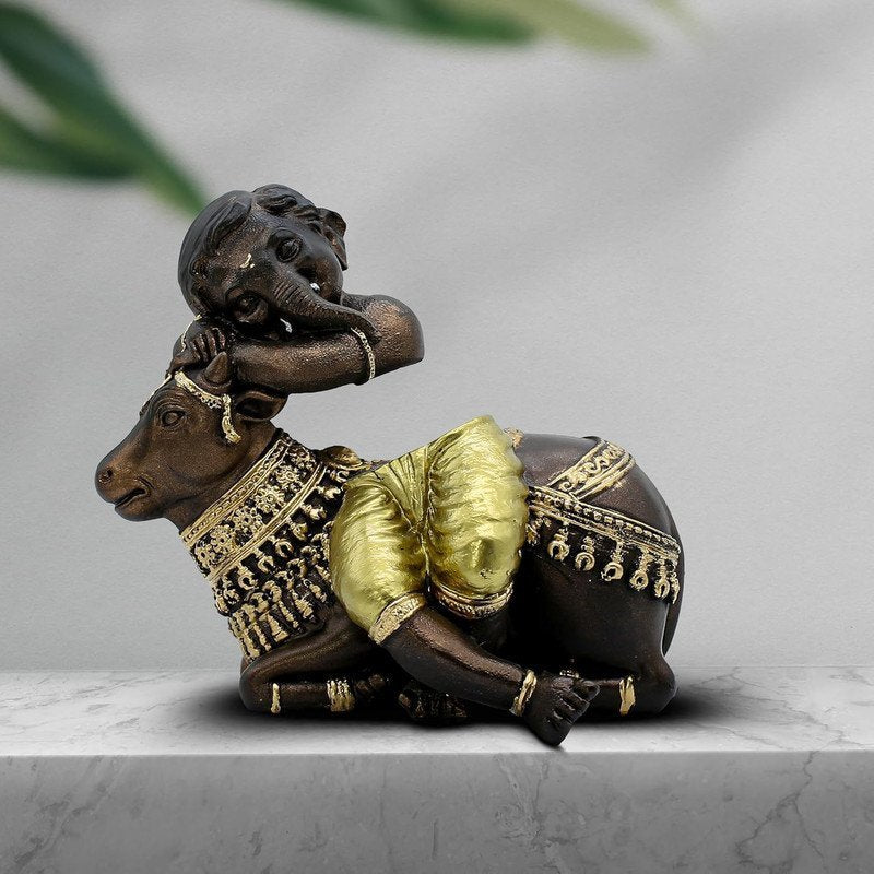Baby Ganesha Idol Resting on Cow Antique Finish Polyresin Ganpati Murti with Golden Dhoti for Home Decor, Pooja Room & Gift, 6 Inch