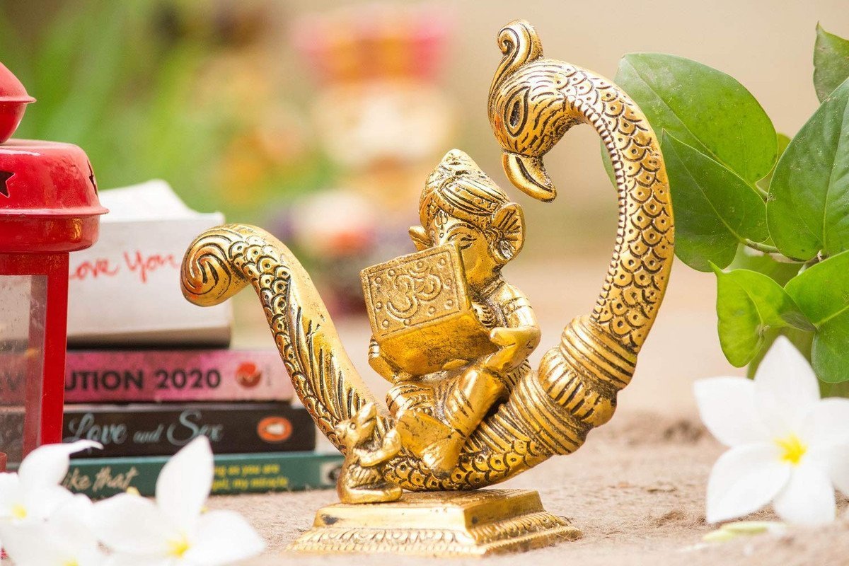 Cute Baby Ganesha Reading Book Idol